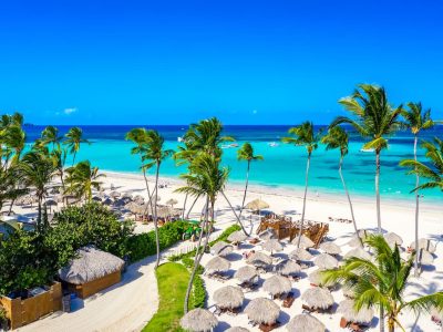 aerial-view-caribbean-tropical-beach-with-straw-umbrellas-palms-boats-bavaro-punta-cana-dominican-republic-1